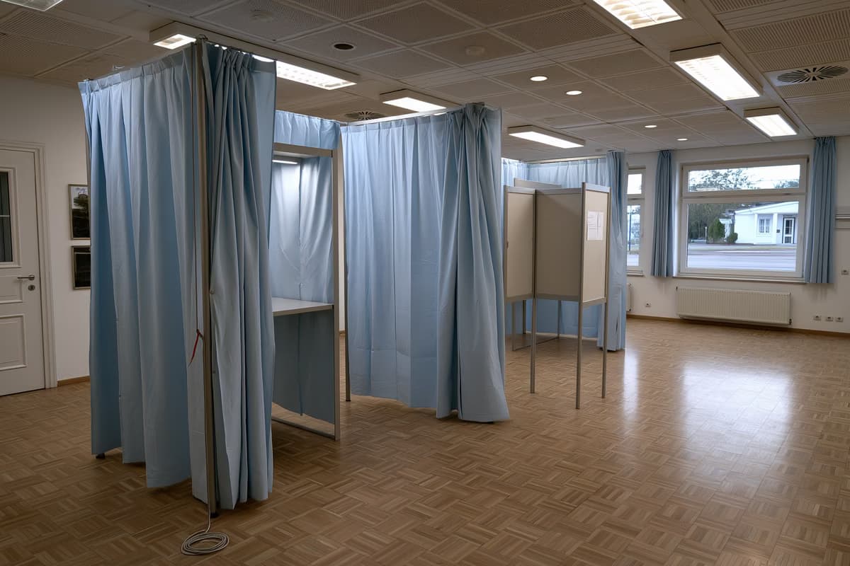Una cabina elettorale vuota con una matita appesa a un filo in una sala comunale tedesca.